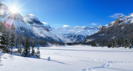 Winter mountain landscape with sun over frozen lake and footprints