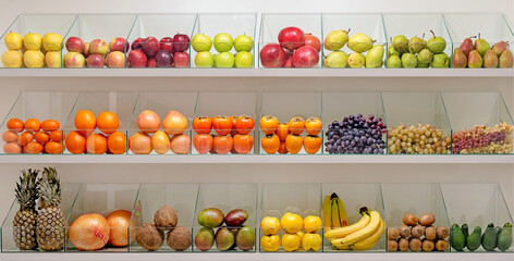 A fruit display with a variety of fruits including apples, oranges, bananas