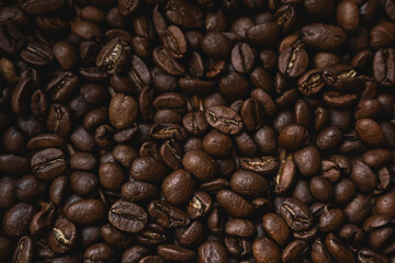 Roasted coffee beans creating a rich brown texture background for beverage, energy, and gourmet concepts