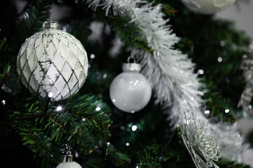 Christmas tree decorated with white silver ornaments