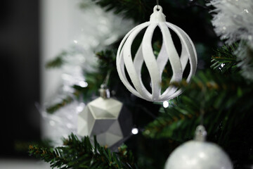 White Christmas ornament hanging on tree