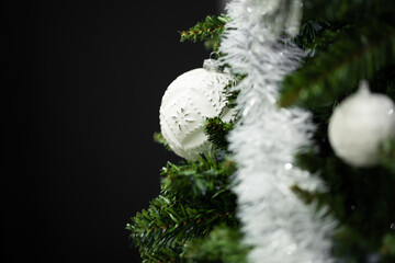 Christmas tree decorating with white snowflake ornament