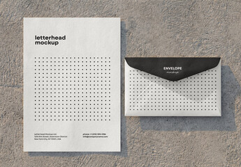 Template Mockup Letterhead and Envelope Branding on Concrete Surface