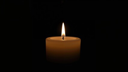 A lit candle against a dark background.