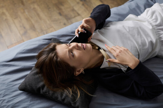 Relaxing day in bed as a young woman spends time alone in her cozy apartment