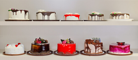 A row of cakes with different flavors and decorations