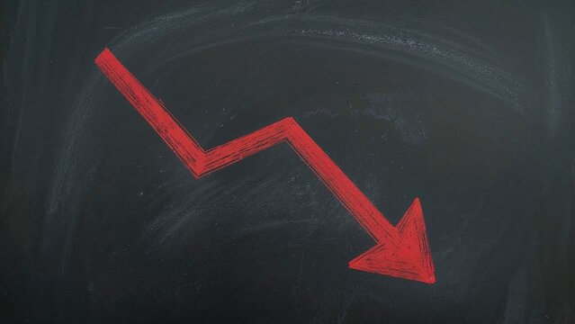 Downward trend arrow on blackboard, economic decline concept. Financial data analysis, market downturn, and business loss representation. The concept of economic decrease and decline.