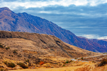 A mountain range with a cloudy sky in the background