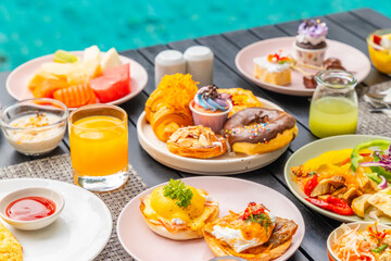 Brunch buffet by pool with vibrant pastries, fresh fruit, savory