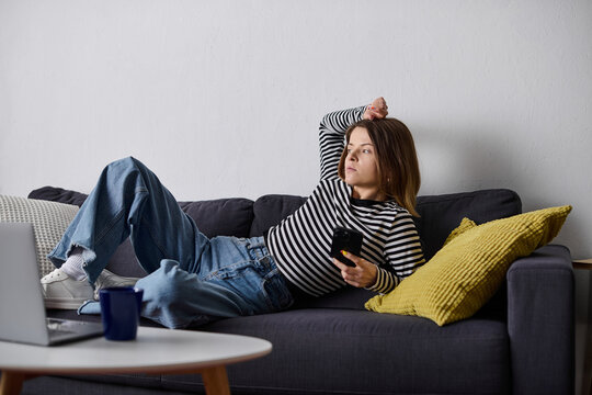 Relaxing day for a young woman embracing self-care in her cozy apartment - Powered by Adobe