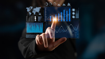 A business professional engages with a futuristic touchscreen displaying various data visualizations, offering insight into performance metrics and analytics trends. Scalp