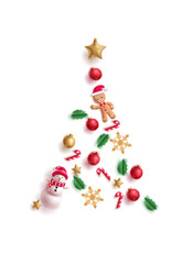 Creative Christmas tree made from realistic holiday ornaments, a snowman, gingerbread man, candy canes, and a golden star.