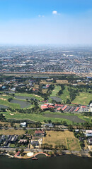 Fototapeta premium Aerial view of urban area, golf course and lake in Samut Prakan,Thailand, Southeast Asia.
