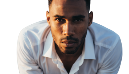 Intense Close-up Portrait of a Young Man with Direct Gaze under Dramatic Golden Light