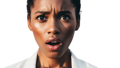 Close-up portrait of a young Black woman expressing deep surprise with wide eyes and open mouth