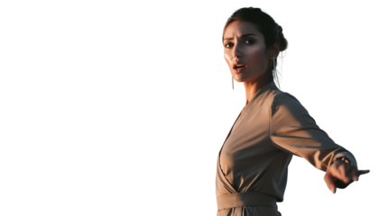 Woman in warm light looking back and pointing with an urgent facial expression