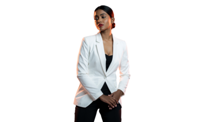 Professional young adult woman in a white blazer posing confidently in a studio