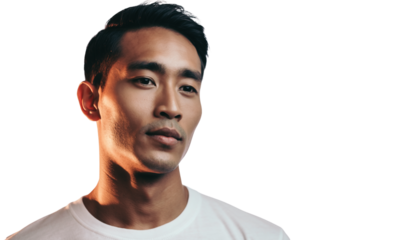 Young adult male portrait in a studio, thoughtfully looking away with dramatic lighting