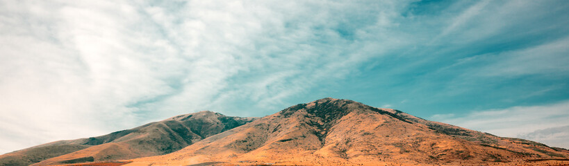 A mountain range with a clear blue sky in the background
