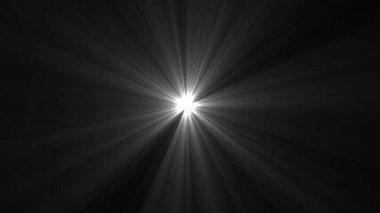 A bright white light source radiating beams against a dark background