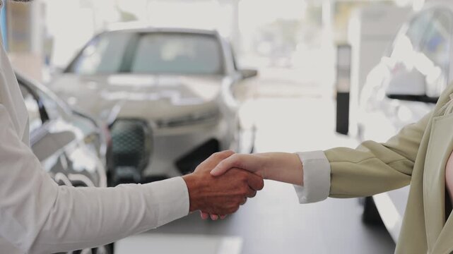 Close up cropped man customer male buyer client taking keys fob from seller chooses auto wants to buy new automobile in car showroom vehicle salon dealership store motor show indoor. Sales concept