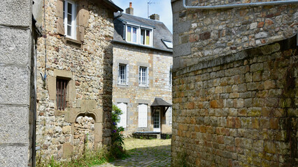 Residential Courtyard with Stone Cottage Walls in Domfront, France