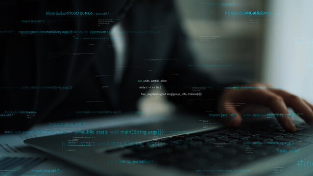 A focused professional in a dark suit engages with a laptop, immersed in programming tasks. The image captures a digital workspace surrounded by code snippets, illustrating modern technology. Xenic