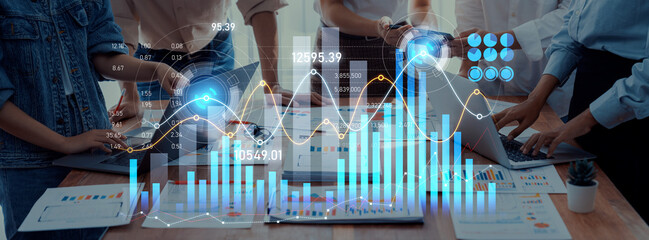 Diverse business team collaborates on financial data analysis using modern digital devices, showcasing charts and graphs for informed decision-making in a professional environment. Scalp