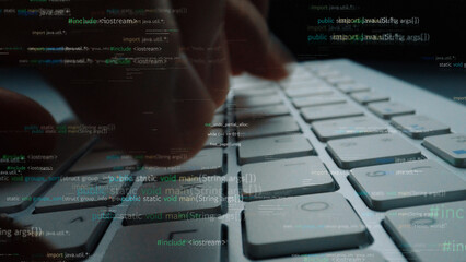 Close-up image showcasing hands typing on a keyboard, overlaid with computer code and programming syntax that represent a technology-driven workspace. Xenic