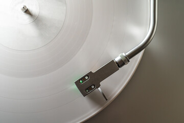 Vinyl record player top view. White disc with tonearm, analog audio, retro music nostalgic minimal stylish sound technology lifestyle.