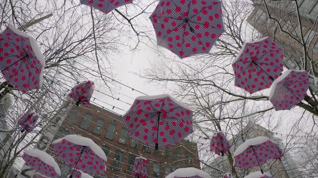 Yaletown Hanging Umbrellas in Snow 4K UHD.Hanging umbrellas in Bill Curtis Square in Vancouver&rsquo;s Yaletown neighborhood in the snow. 4K, UHD.
