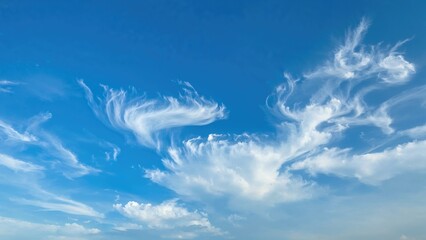 Clouds in the sky with wispy and fluffy formations. Nature and weather scene. Sky and atmospheric conditions. The concept of sky and cloud patterns