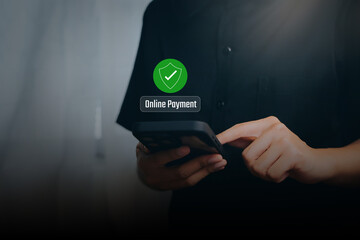 Secure payment concept. Person using smartphone with online payment shield icon, digital transaction protection, financial security, cashless society, fintech trust and safety system.