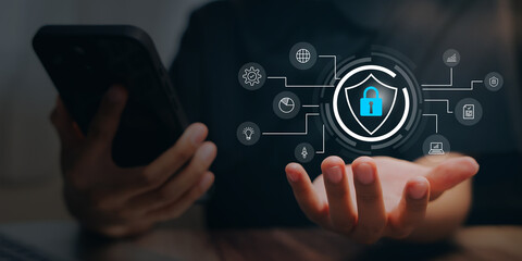 Cyber security concept. Hand holding virtual shield with lock icon and network symbols, data protection system, information safety, privacy control, digital defense technology.