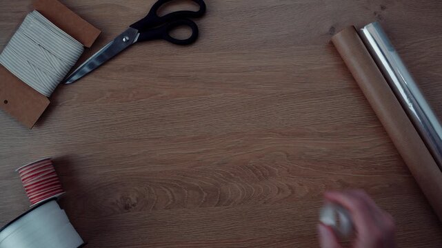 Watch as the process of making an easy DIY project unfolds. Using scissors, tape, and cardboard, the setup transforms with simple hands-on steps