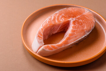 Fish, raw salmon steak, fresh seafood for grilling with salt, spices, and herbs. Raw salmon steak