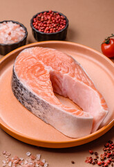 Fish, raw salmon steak, fresh seafood for grilling with salt, spices, and herbs. Raw salmon steak