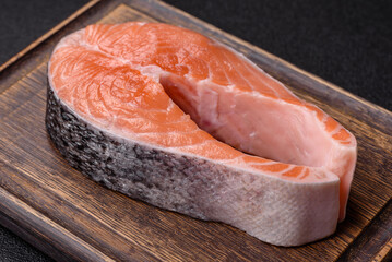 Fish, raw salmon steak, fresh seafood for grilling with salt, spices, and herbs. Raw salmon steak