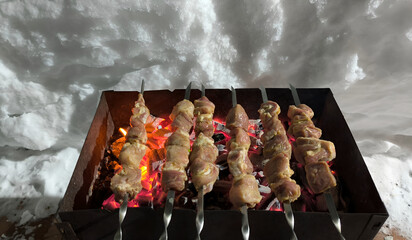 shashlik is grilled on the grill in winter