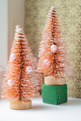 Soft focus Christmas background with red toy Christmas tree, vertical frame