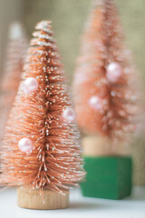 A toy Christmas tree in a soft retro filter, vertical frame