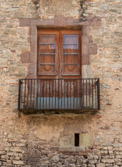 Weathered Wooden Windows and Ironwork Balconies on an Old Town Building