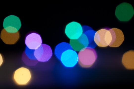 Soft, multicolored bokeh lights glowing against a dark background, creating a dreamy festive atmosphere.