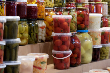 Colorful jars of preserved vegetables in a vibrant market display