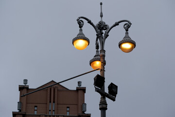 Elegant streetlight illuminating a quiet city scene at dusk