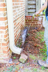 Termite treatment on the foundation of a house.