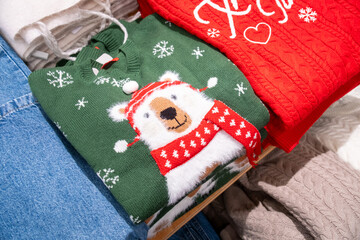 Green Christmas sweater featuring a playful polar bear wearing a red scarf, surrounded by snowflakes, perfect for holiday celebrations. Cozy knitwear design conveys warmth and cheer. © Наталья Майшева