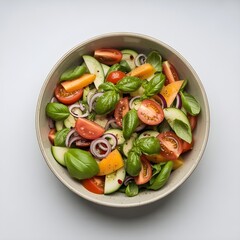 Fresh tomato and cucumber salad with basil leaves in a bowl