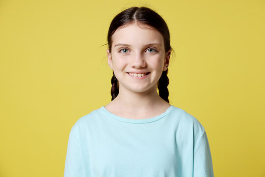 Portrait of cute girl on yellow background