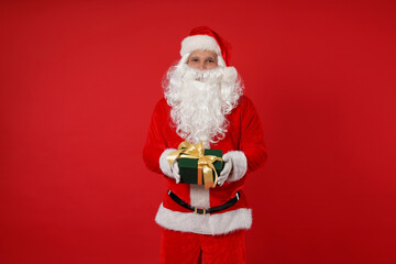 Santa Claus with Christmas gift on red background